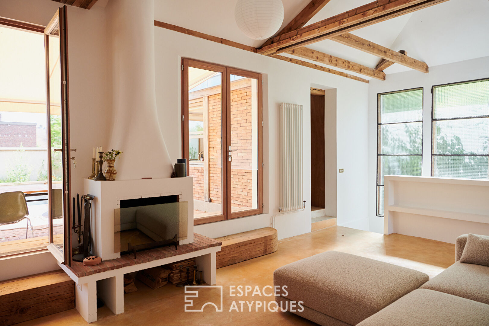 House with photo studio in raw and seventies style