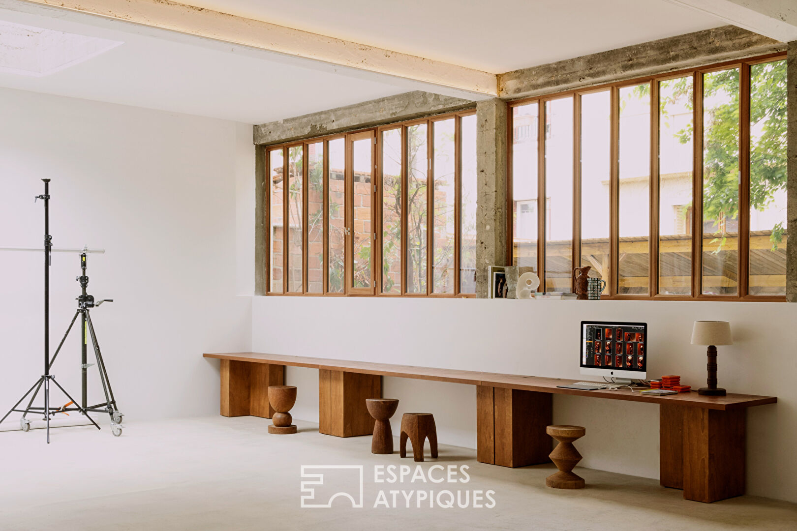 House with photo studio in raw and seventies style
