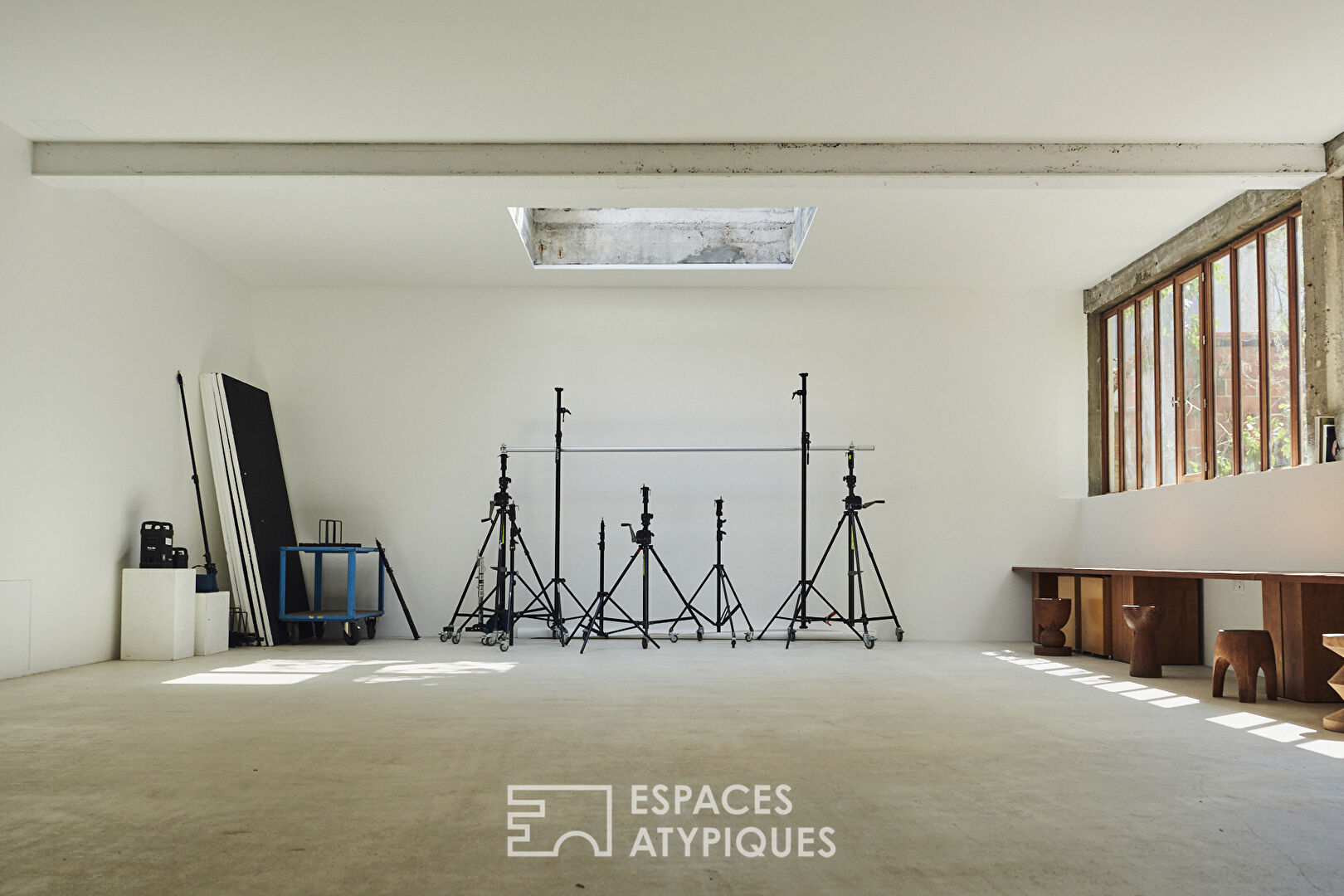House with photo studio in raw and seventies style