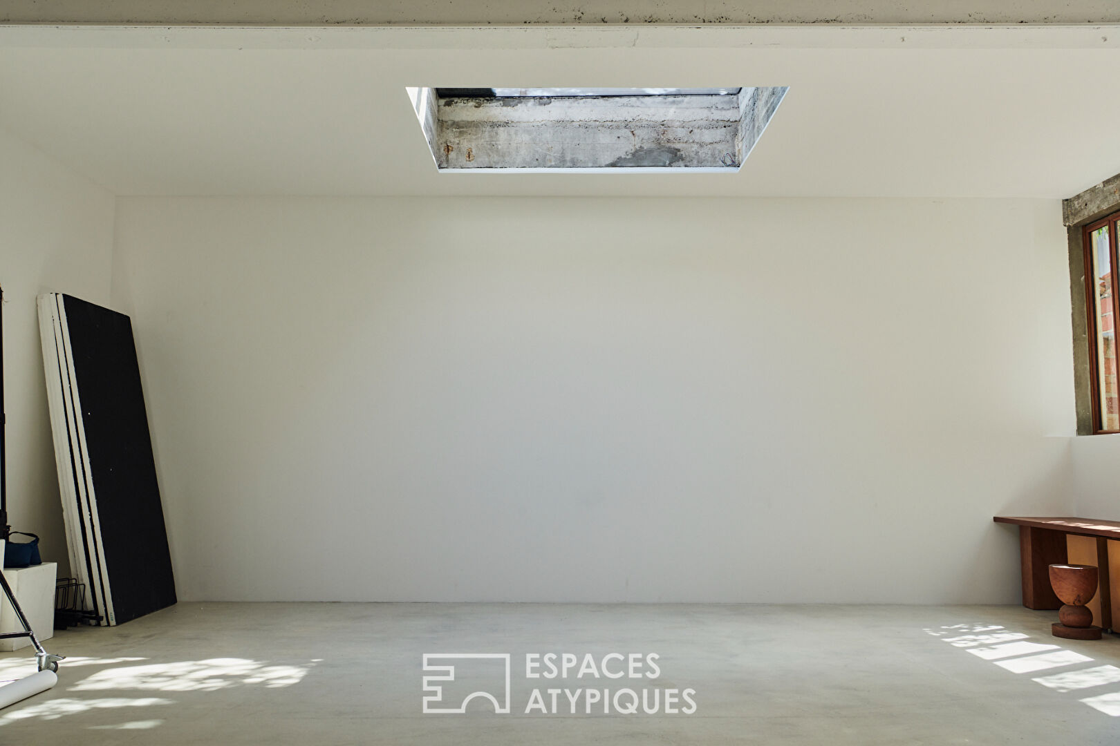 House with photo studio in raw and seventies style
