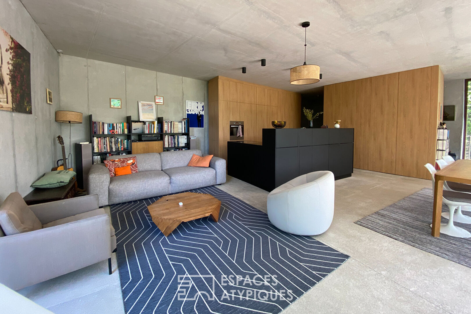 Brutalist house with wooden terrace in the middle of the forest